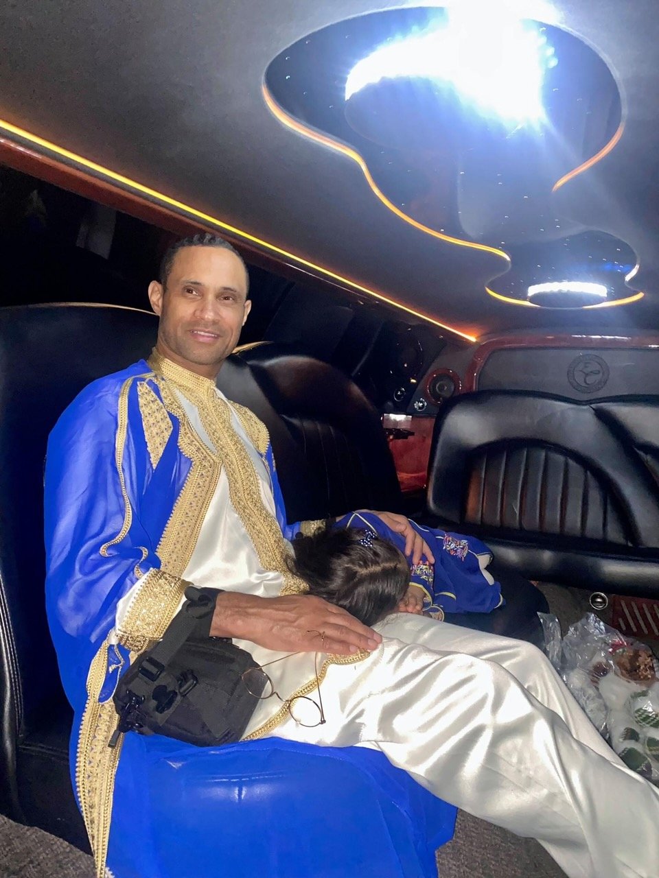 In traditional dress, our daughter asleep on my lap